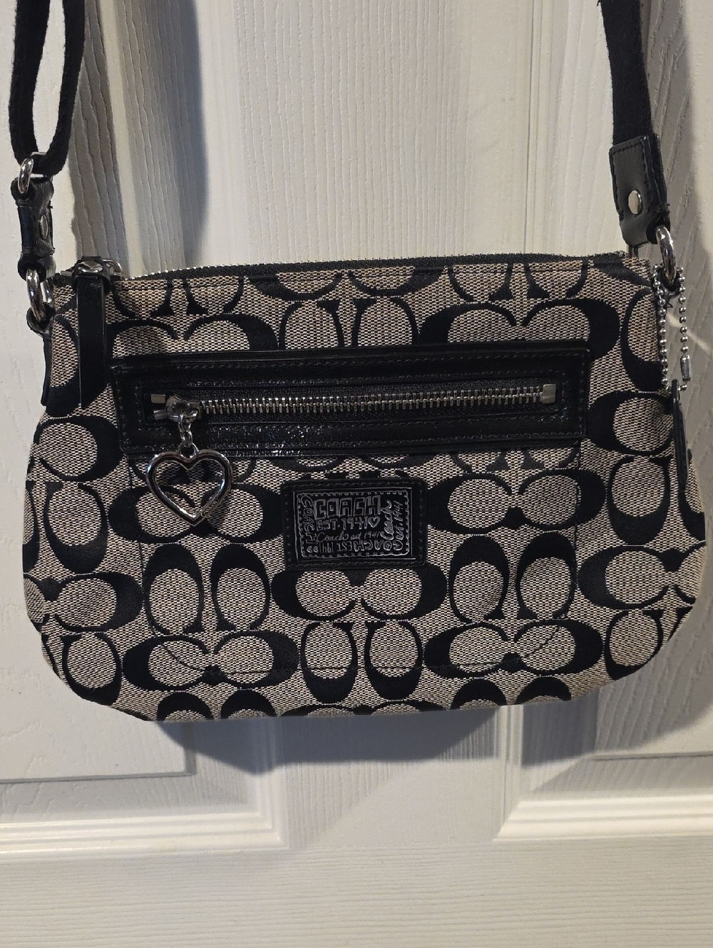 Coach Poppy Signature Small Crossbody Bag featuring the brand's iconic "C"